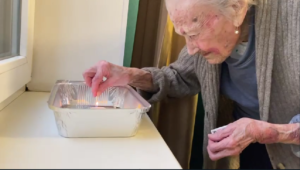Tatiana, a 100-year-old Holocaust survivor from Ukraine asked to light candles in honor of the holiday